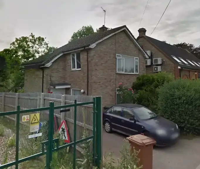A domestic property in Hertfordshire with a black car parked outide.