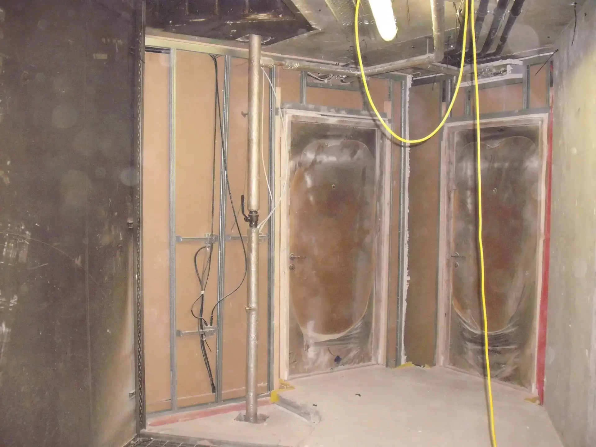 Fire damaged walls and exposed wiring inside of a university dorm.