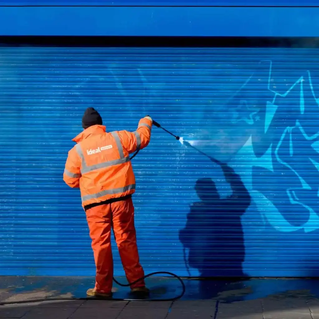 Cleaning graffiti off a building