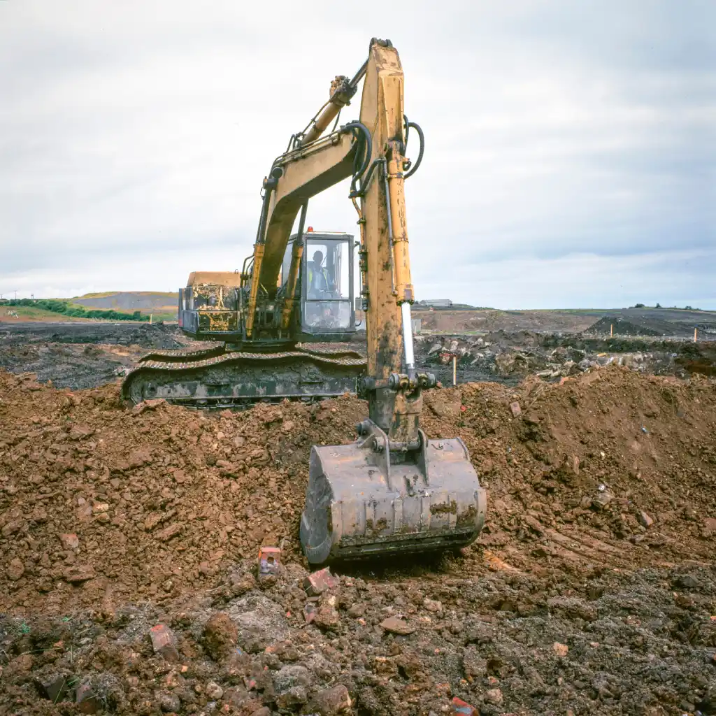 Technician in JCB undertaking remediation work on site of former coal mine in the north of England.